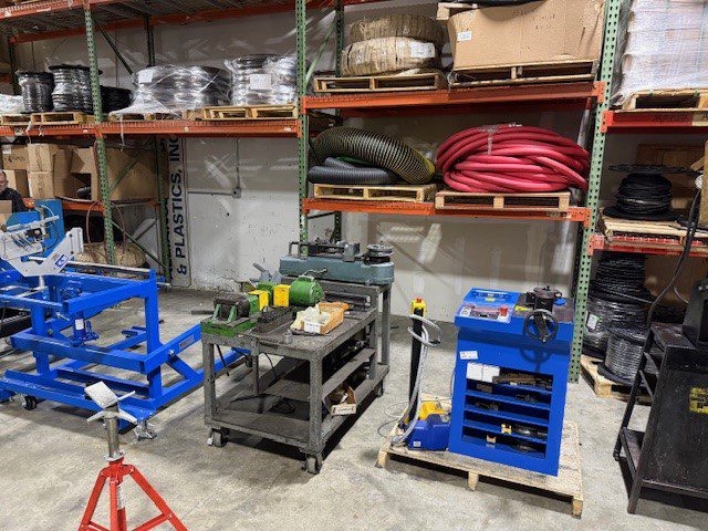 Industrial workshop area with machinery and organized shelves.