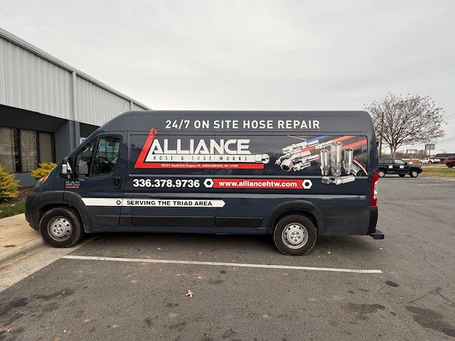 Alliance site hose repair service van parked outdoors.