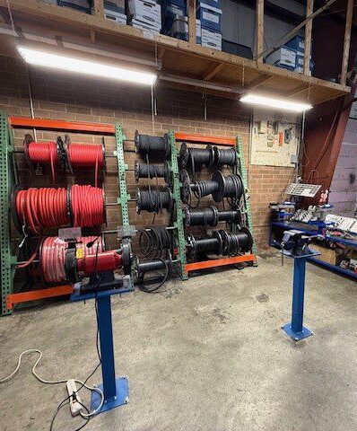 Organized workshop with hoses and tools neatly stored on racks.
