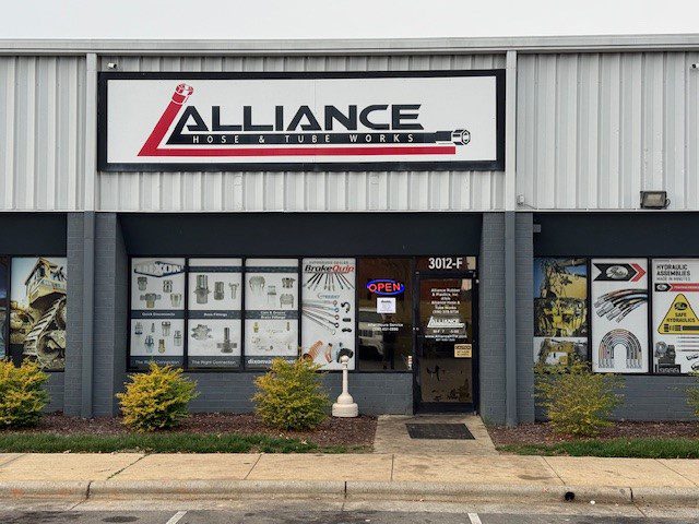 Front view of Alliance Real Estate Group storefront with signage and window displays.