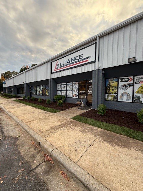 Exterior view of a business building under a cloudy sky.