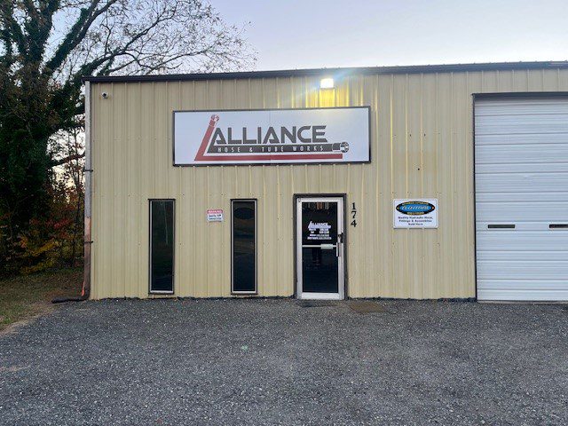 Front view of Alliance Welding & Fabrication building with signage and entrance door.